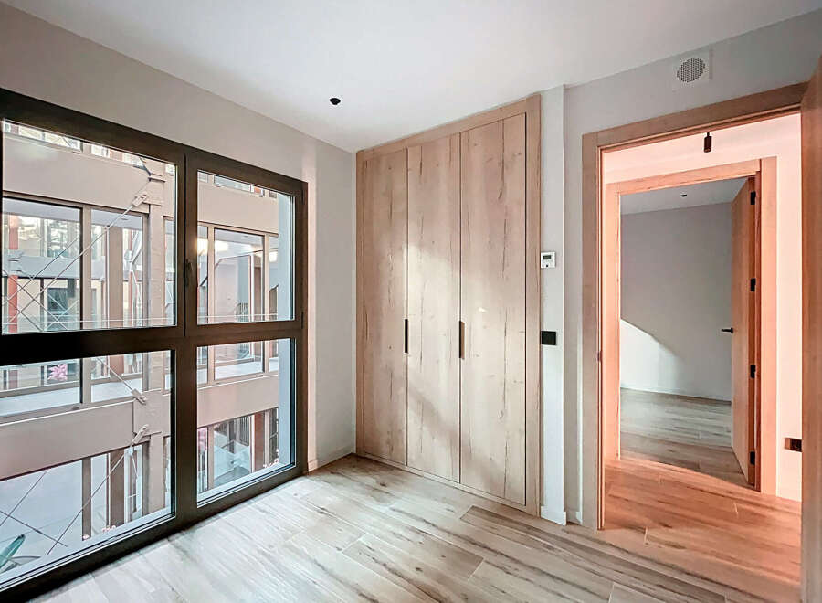 Discover the elegance of this modern property, featuring a spacious interior with natural light pouring in through large windows.