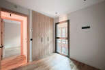 Discover the elegance of this modern space, featuring a beautifully designed built-in wardrobe with sleek black handles.