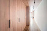 This stunning property features a beautifully designed hallway with custom wooden cabinetry.