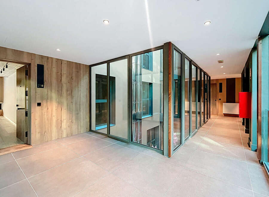 Discover modern elegance in this stunning property, featuring sleek glass walls and a contemporary design.