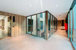 Discover modern elegance in this stunning property, featuring sleek glass walls and a contemporary design.