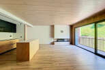 Stunning open-plan living space with a modern kitchen and built-in fireplace.