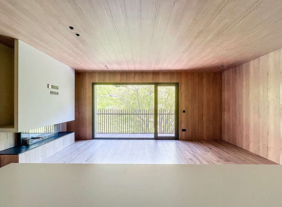 Stunning modern living space with floor-to-ceiling windows offering breathtaking views.