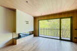 Modern living space with a built-in fireplace and large windows offering scenic views.