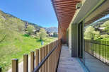 This stunning property boasts a spacious balcony with breathtaking mountain views.