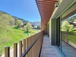 This stunning property boasts a spacious balcony with breathtaking mountain views.