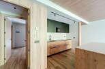 Modern kitchen with wooden cabinets and sleek countertops.