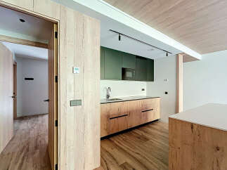 Modern kitchen with wooden cabinets and sleek countertops.