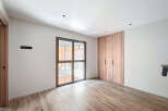 This stunning property boasts a spacious bedroom with ample natural light from a large window.