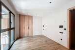 This stunning property boasts a modern, minimalist design with light wood flooring and built-in wardrobes.