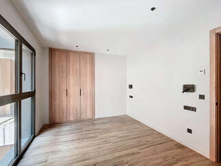 This stunning property boasts a modern, minimalist design with light wood flooring and built-in wardrobes.