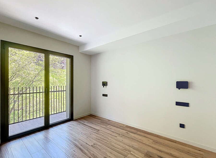 Bright and airy room with large balcony doors, offering plenty of natural light.