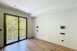 Bright and airy room with large balcony doors, offering plenty of natural light.