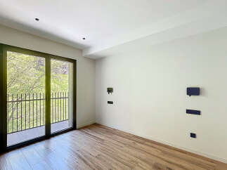 Bright and airy room with large balcony doors, offering plenty of natural light.