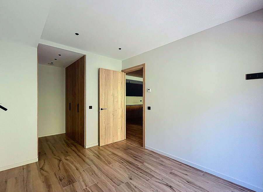This stunning property boasts a modern, minimalist design with light, neutral walls and rich wood flooring.