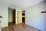 This stunning property boasts a modern, minimalist design with light, neutral walls and rich wood flooring.