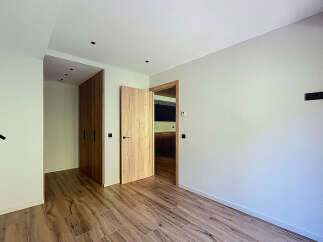 This stunning property boasts a modern, minimalist design with light, neutral walls and rich wood flooring.