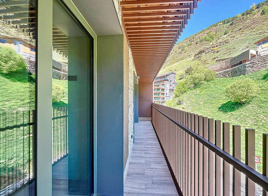 This stunning property boasts a modern balcony with breathtaking mountain views.