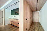 Modern apartment with stylish wooden features and a sleek kitchen.