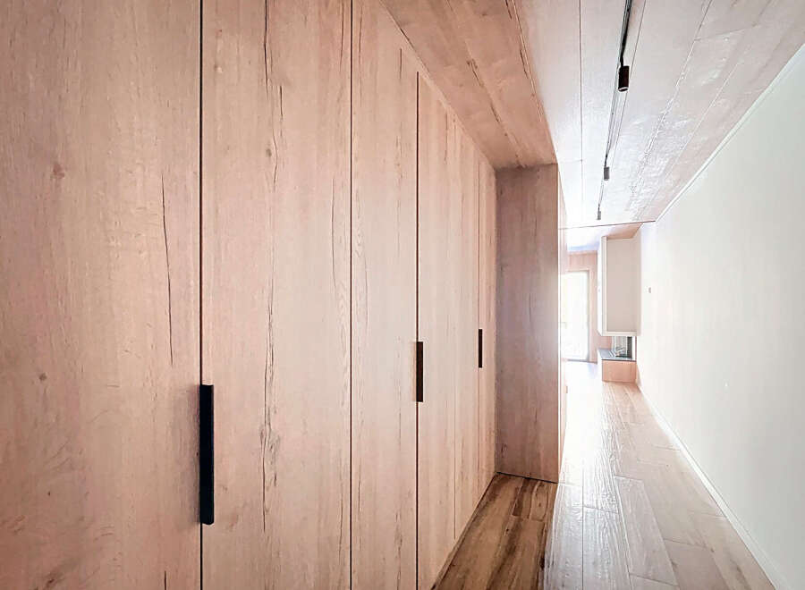 Step into modern elegance with this stunning property featuring custom wood paneling and sleek black hardware.