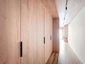 Step into modern elegance with this stunning property featuring custom wood paneling and sleek black hardware.