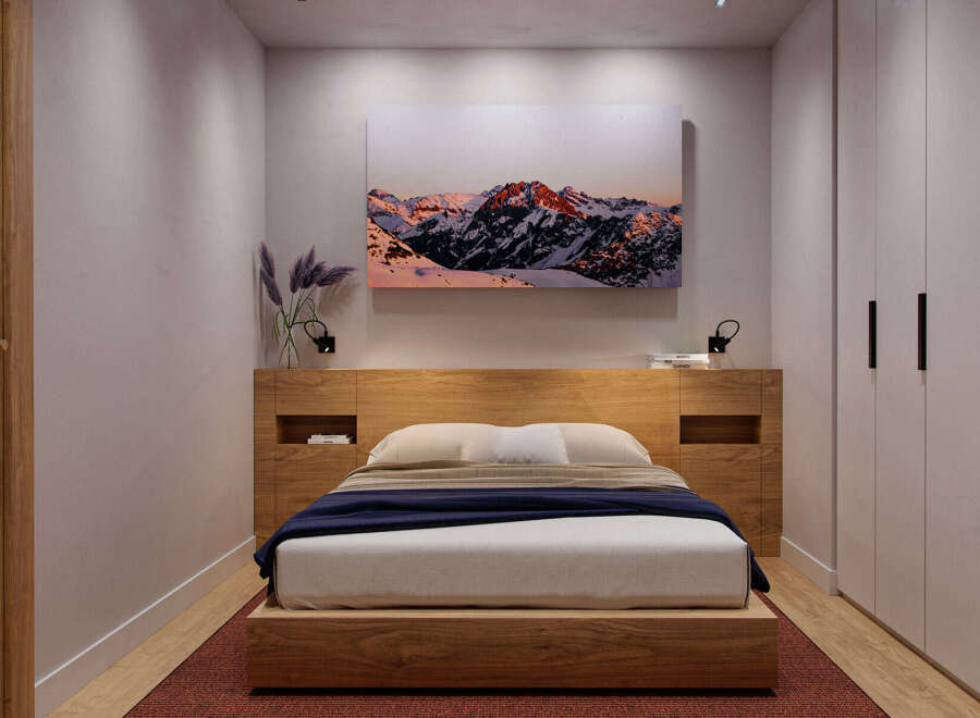 Cozy bedroom with built-in wooden headboard and platform bed, offering ample storage with integrated shelving and a spacious wardrobe.