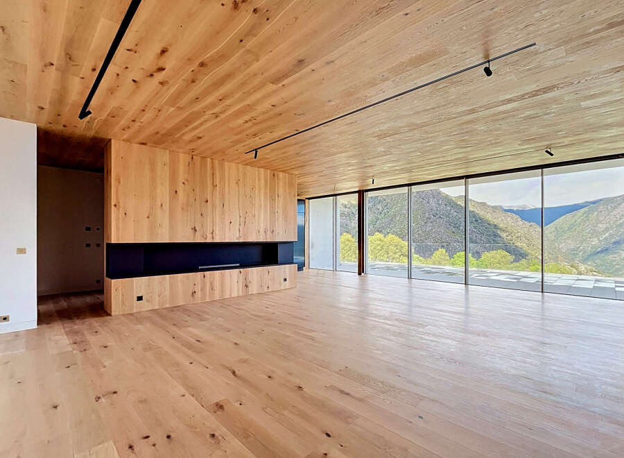 Experience luxury living in this stunning property, featuring a spacious interior with natural wood finishes.