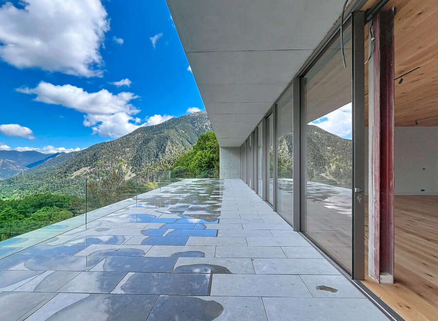 Experience breathtaking mountain views from this modern architectural masterpiece.