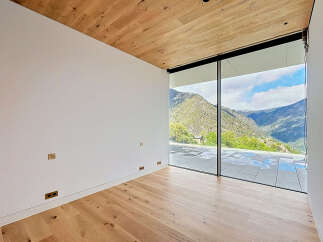 Experience breathtaking views from this modern property featuring expansive windows that frame the stunning mountain landscape.
