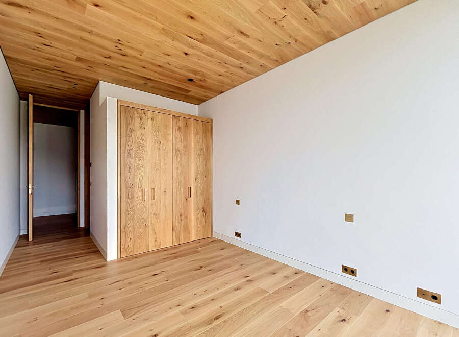 This stunning room boasts a warm and inviting atmosphere with its beautiful wooden floors and ceiling.