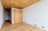 This stunning room boasts a warm and inviting atmosphere with its beautiful wooden floors and ceiling.
