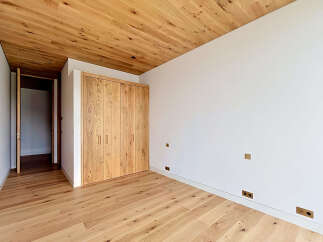 This stunning room boasts a warm and inviting atmosphere with its beautiful wooden floors and ceiling.