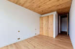 This stunning room features a beautiful wooden ceiling and flooring, creating a warm and inviting atmosphere.