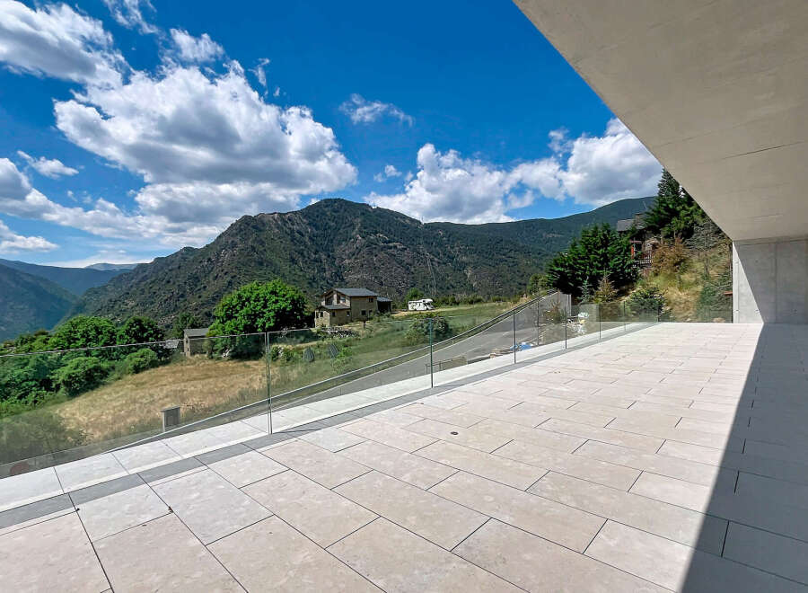 Experience breathtaking mountain views from this modern property's expansive terrace.