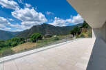 Experience breathtaking mountain views from this modern property's expansive terrace.