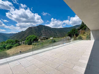 Experience breathtaking mountain views from this modern property's expansive terrace.