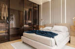 This stunning bedroom boasts a built-in wardrobe with mirrored sliding doors, offering ample storage space.