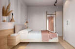 This stunning bedroom boasts a minimalist design with a light and airy feel.