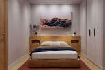 Cozy bedroom with built-in wooden headboard and platform bed, offering ample storage with integrated shelving and a spacious wardrobe.