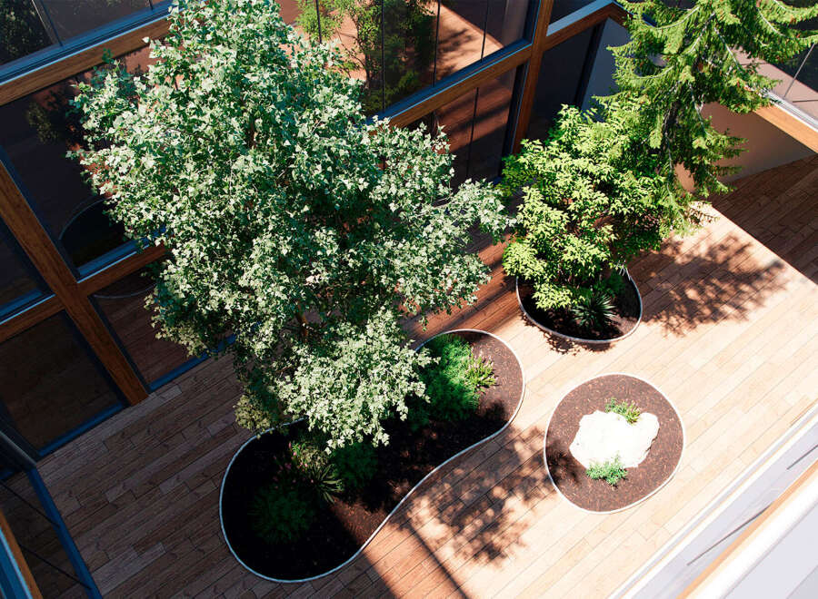 This stunning property boasts a unique, light-filled atrium with lush greenery and mature trees, creating a tranquil oasis in the heart of the building.