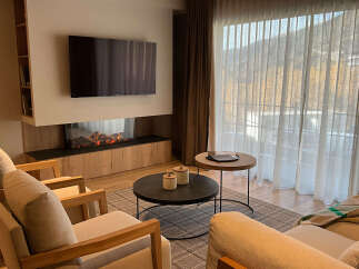 Experience luxury living in this stunning property, featuring a modern fireplace and a sleek TV setup, perfect for cozy evenings.