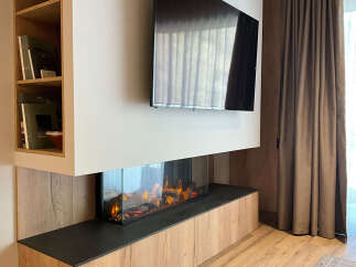 This modern living space features a sleek fireplace and a mounted television, creating a cozy and stylish ambiance.