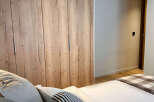 This stunning bedroom features a beautiful wooden wardrobe, offering ample storage space and adding a touch of natural elegance.