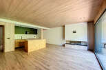 Stunning open-plan living space with modern kitchen and wood-burning fireplace.