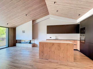 This stunning modern kitchen boasts a sleek design with a wooden island and cabinetry.
