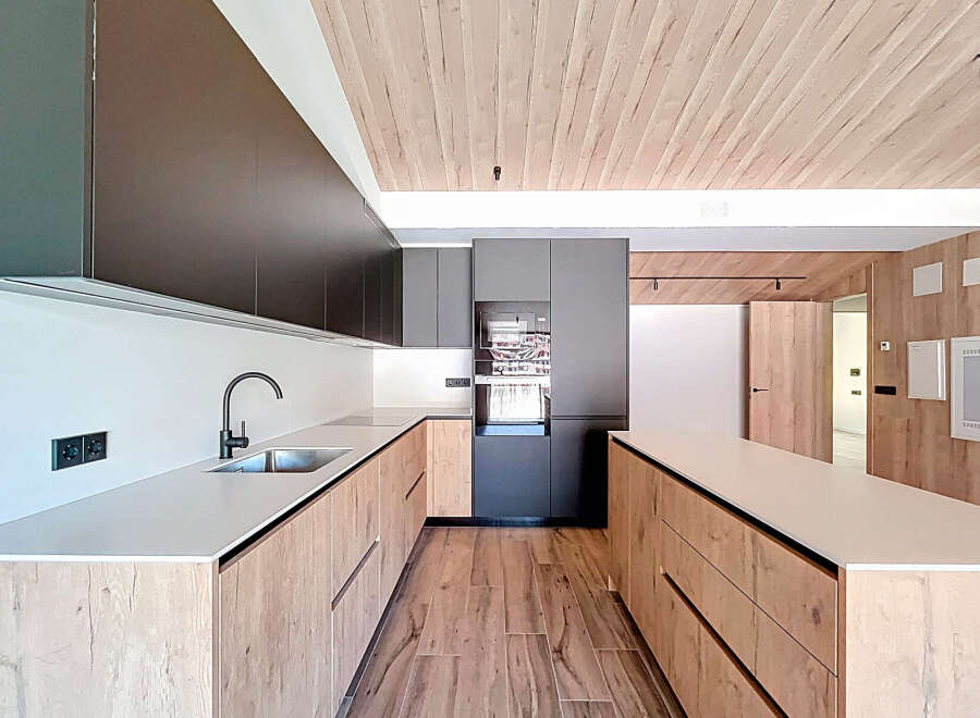 This stunning kitchen boasts a modern design with sleek cabinetry and a spacious layout, perfect for culinary enthusiasts.