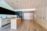This modern kitchen boasts a sleek design with wooden accents, creating a warm and inviting atmosphere.