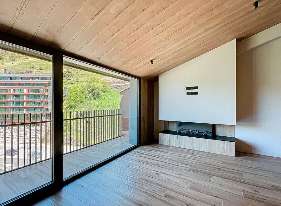 Experience luxury living in this stunning property featuring a modern fireplace and expansive windows.