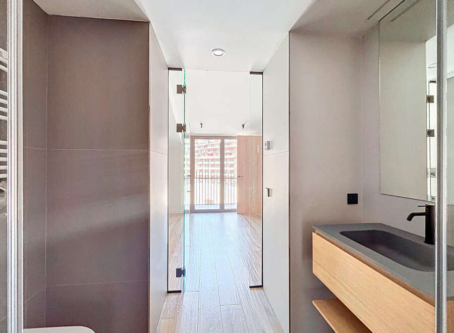 Step into modern luxury with this stunning property! Featuring a sleek bathroom design with a floating vanity and a glass-enclosed shower, this home offers both style and functionality.