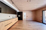 This modern kitchen boasts a sleek design with wooden cabinetry and a minimalist aesthetic.